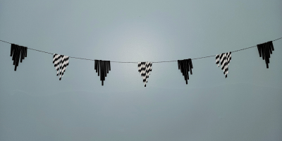 Black and White garland made from paper straws, hanging on wall